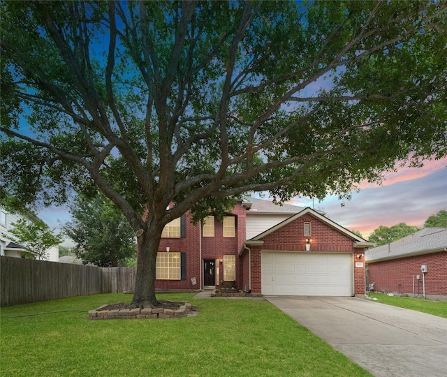 view of front of property featuring a yard and a garage