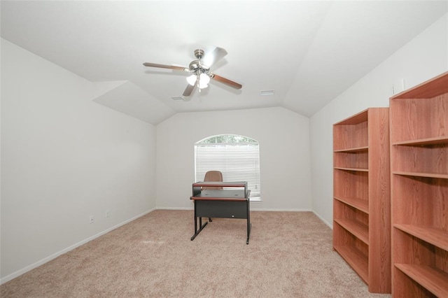 carpeted office with ceiling fan and vaulted ceiling