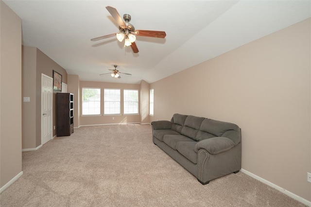 carpeted living room with ceiling fan