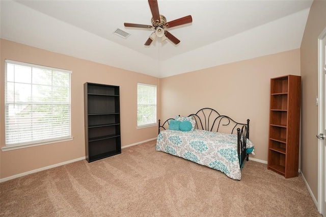 bedroom featuring ceiling fan, light carpet, and vaulted ceiling