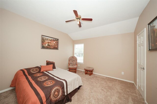 carpeted bedroom featuring vaulted ceiling and ceiling fan