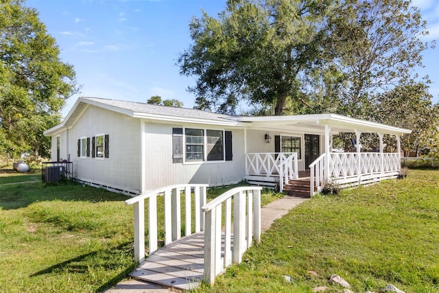 view of front of house with cooling unit, a front lawn, and a porch