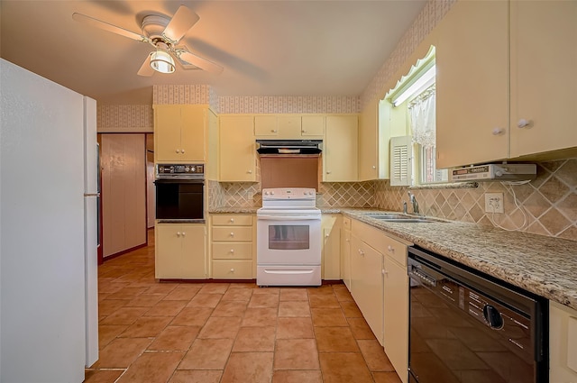 kitchen with ceiling fan, sink, cream cabinets, black appliances, and exhaust hood