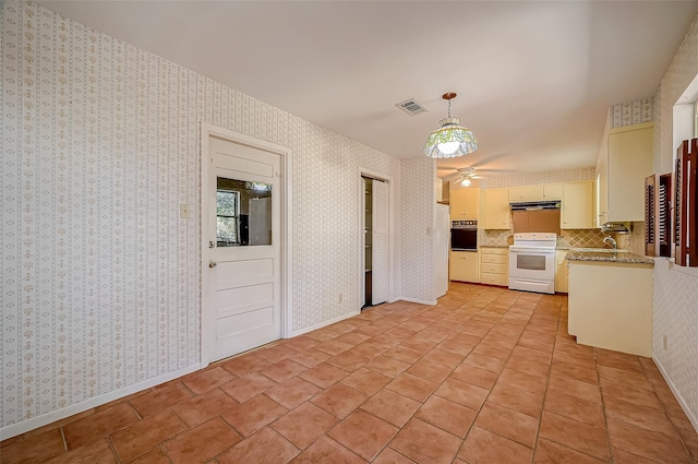 kitchen featuring tasteful backsplash, white range with electric stovetop, oven, decorative light fixtures, and white cabinets