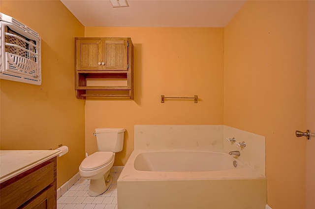 bathroom featuring a washtub, vanity, tile patterned floors, and toilet