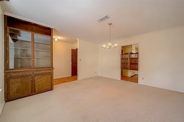 interior space featuring light colored carpet, crown molding, and a chandelier