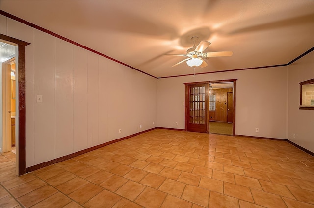 tiled empty room featuring ceiling fan and ornamental molding