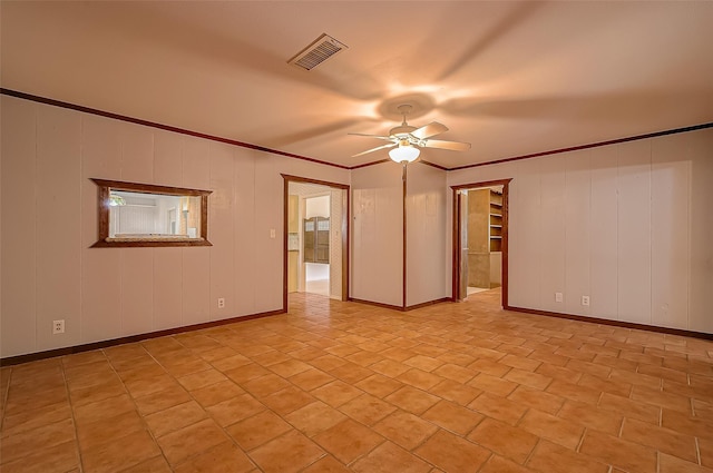 empty room with ceiling fan and ornamental molding