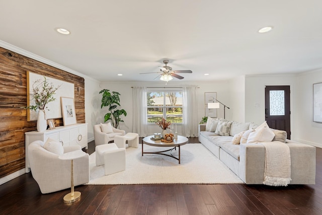 living room featuring ceiling fan, dark hardwood / wood-style flooring, and ornamental molding