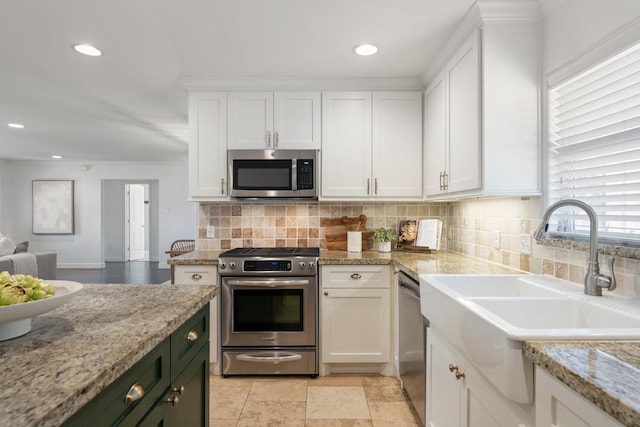 kitchen with white cabinetry, sink, appliances with stainless steel finishes, and tasteful backsplash