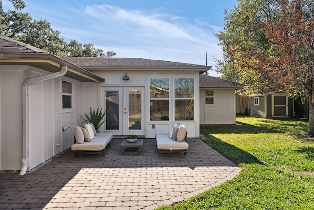 back of property featuring a lawn, french doors, a patio, and a storage unit