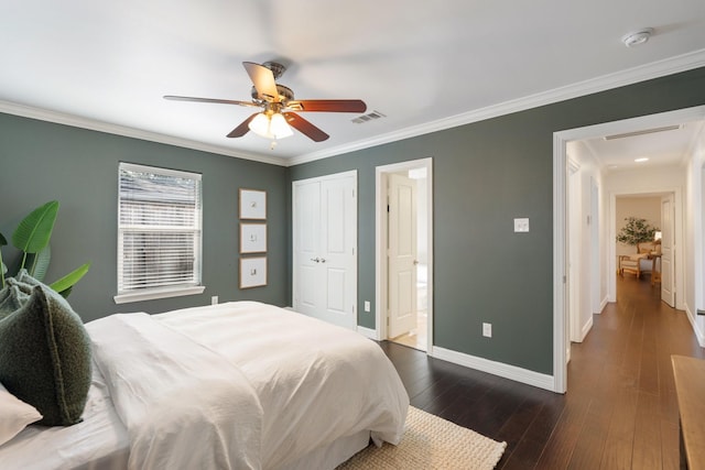 bedroom featuring crown molding, ceiling fan, dark hardwood / wood-style floors, connected bathroom, and a closet