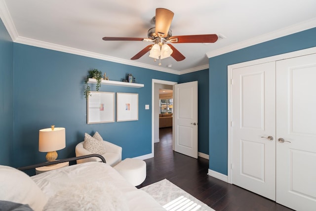 bedroom featuring ceiling fan, a closet, dark wood-type flooring, and ornamental molding