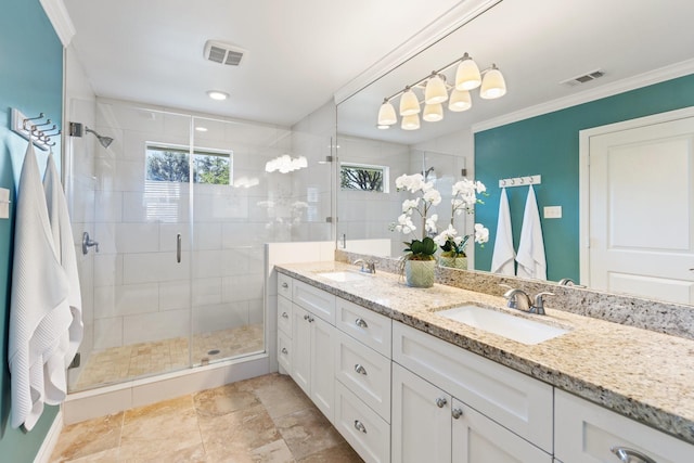 bathroom featuring vanity, a shower with shower door, and ornamental molding