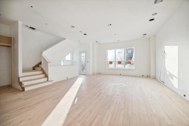 unfurnished living room featuring light wood-type flooring