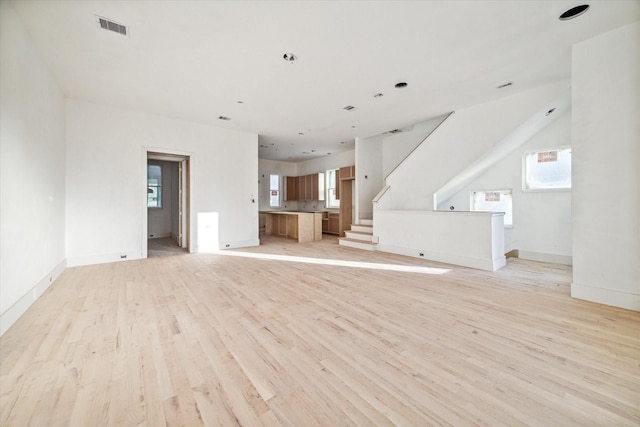 unfurnished living room featuring light wood-type flooring