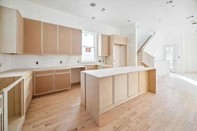 kitchen featuring a wealth of natural light, a center island, and light wood-type flooring