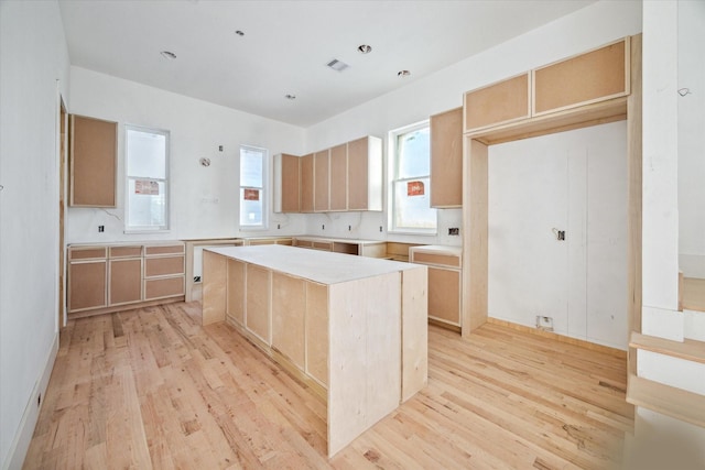 kitchen with a center island and light wood-type flooring