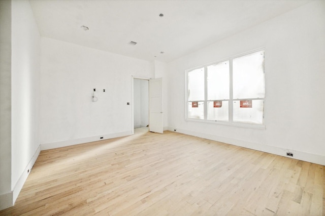 spare room with light hardwood / wood-style flooring