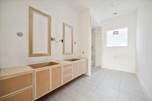 bathroom with tile patterned floors and vanity