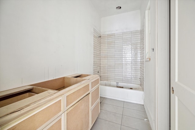 bathroom featuring tile patterned floors and a tub to relax in