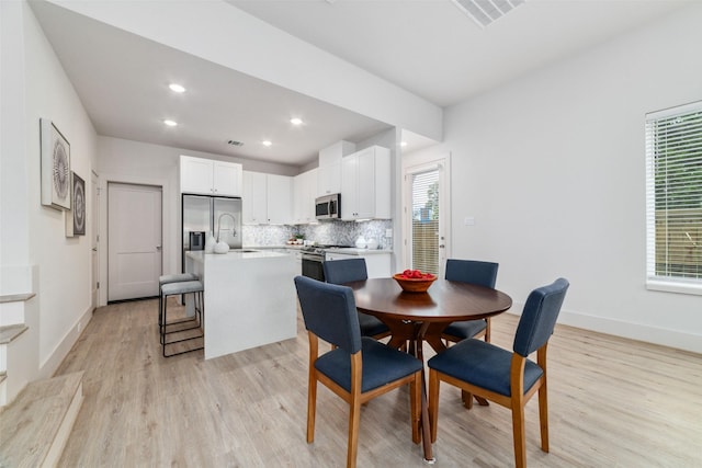 dining space featuring light wood-type flooring