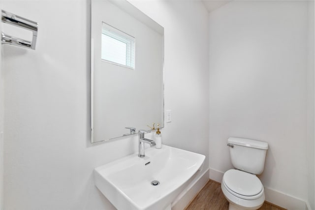 bathroom featuring hardwood / wood-style floors, toilet, and sink