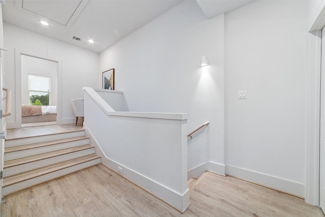 stairs with hardwood / wood-style flooring