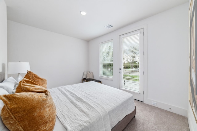 carpeted bedroom with access to exterior