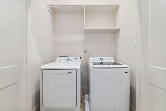 clothes washing area featuring washer and dryer