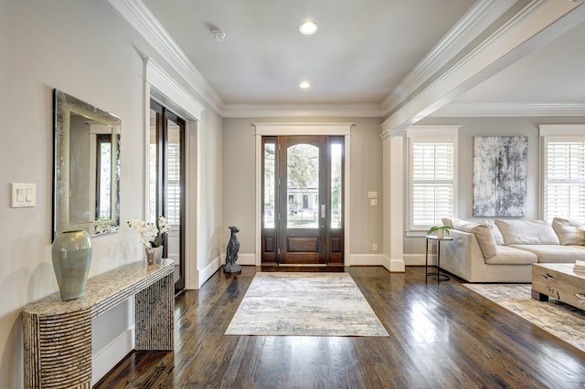 foyer entrance with dark hardwood / wood-style flooring and crown molding