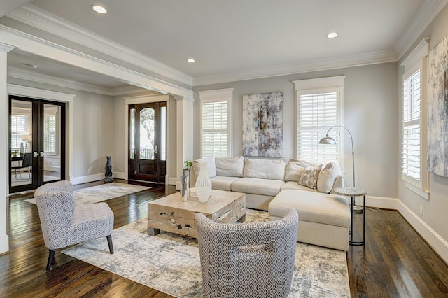 living room with french doors, dark hardwood / wood-style flooring, decorative columns, and crown molding