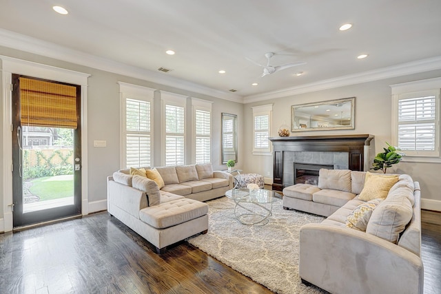 living room featuring ceiling fan, ornamental molding, and dark hardwood / wood-style floors