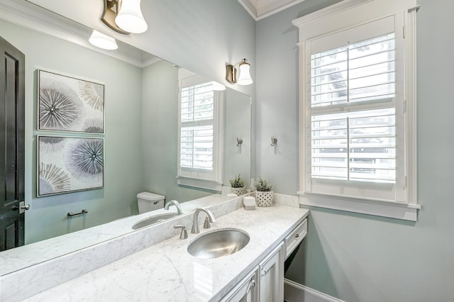 bathroom with ornamental molding, toilet, and vanity