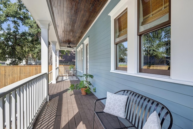 deck with ceiling fan and covered porch