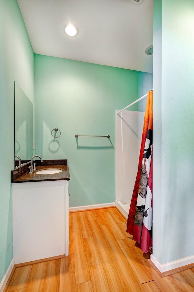 bathroom featuring vanity and wood-type flooring