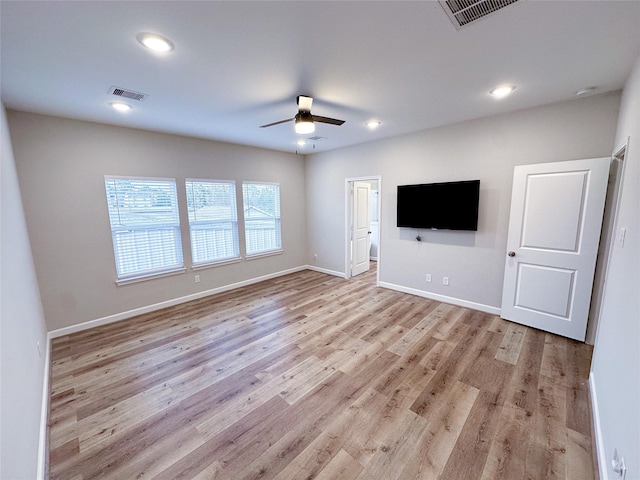 unfurnished living room featuring ceiling fan and light wood-type flooring