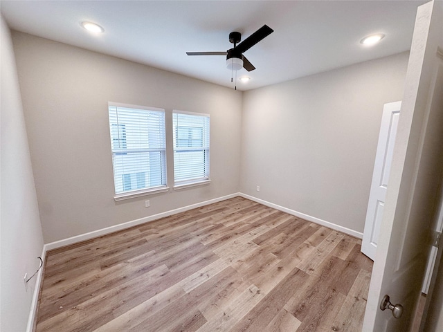 unfurnished room featuring ceiling fan and light wood-type flooring