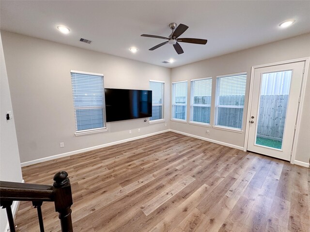 unfurnished living room with ceiling fan and light hardwood / wood-style flooring