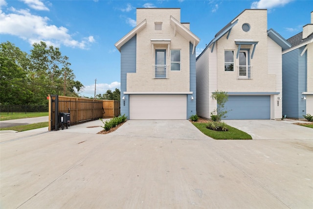 view of front of property featuring driveway, a garage, and fence