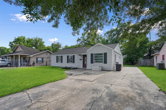 ranch-style house featuring central AC unit and a front lawn