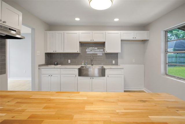 kitchen featuring white cabinets, tasteful backsplash, and sink