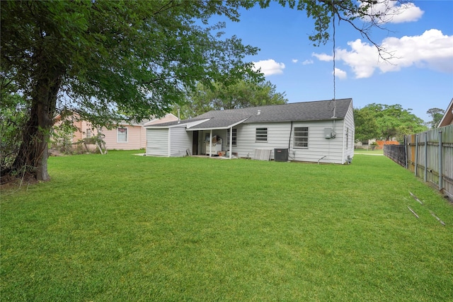 back of property featuring a yard and central air condition unit