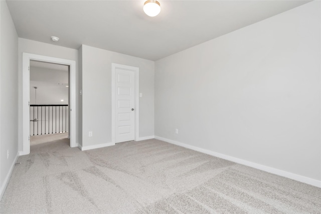 unfurnished bedroom with light carpet and a closet