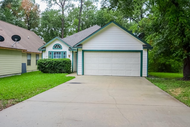 ranch-style home featuring a garage and a front lawn