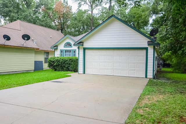 ranch-style home with a front yard and a garage