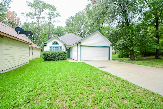 single story home with a garage and a front lawn