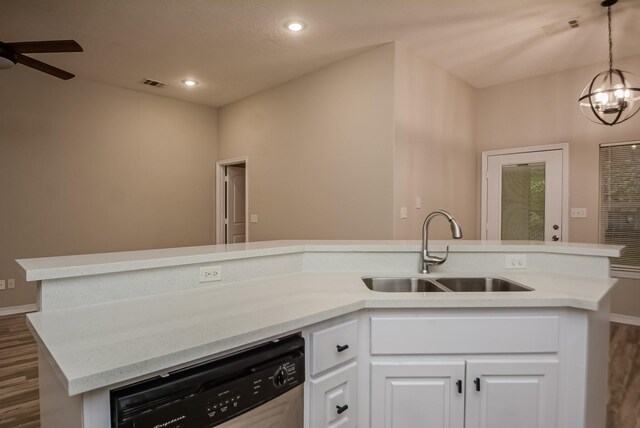 kitchen with ceiling fan with notable chandelier, sink, pendant lighting, dishwasher, and white cabinetry