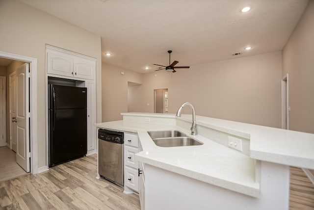 kitchen with ceiling fan, sink, stainless steel dishwasher, black refrigerator, and white cabinets