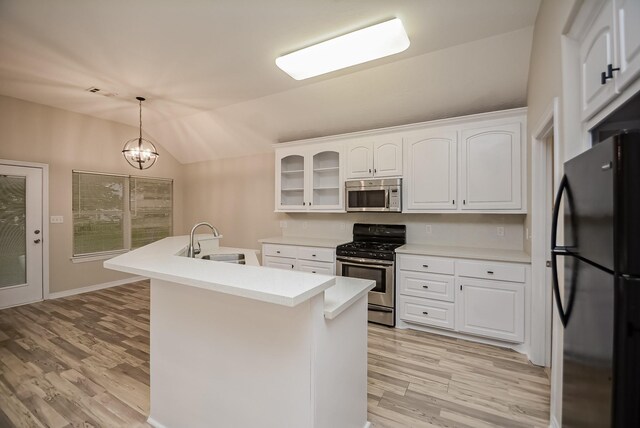 kitchen with pendant lighting, white cabinets, sink, stainless steel appliances, and a chandelier